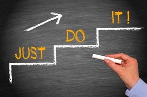 Chalkboard drawing of steps with 'Just Do It', symbolising action and implementation.
